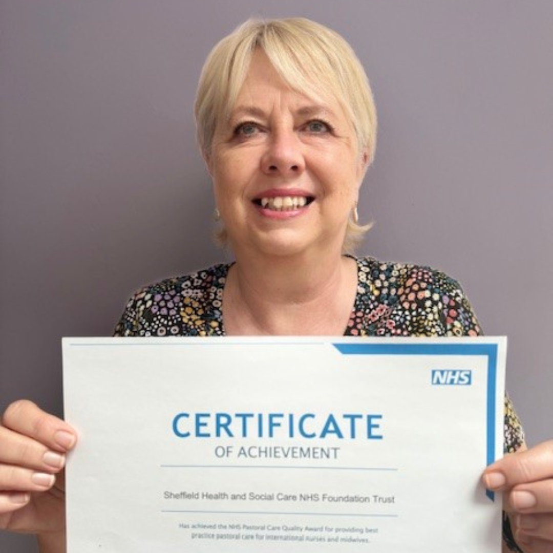 Jo Simms holding a certificate