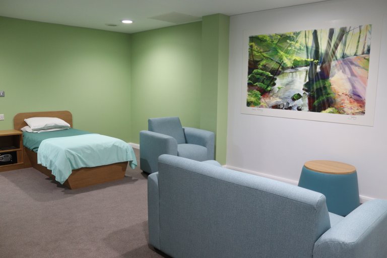 Suite showing bed, sofa, chair and artwork