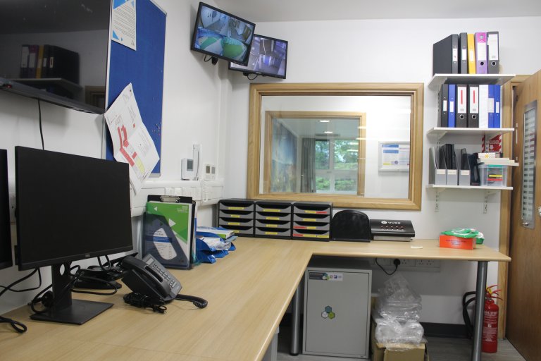 Staff area with desk, computer and phone